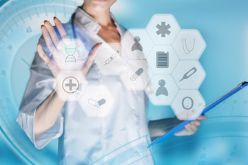 Medical concept of futuristic health care technology and augmented reality. A female doctor hand is touching a virtual innovative control panel to monitor a patient's electronic health records