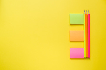 Office supplies on yellow table with copy space. Education concept, school and office.