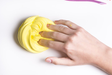 Girl hands playing with yellow slime