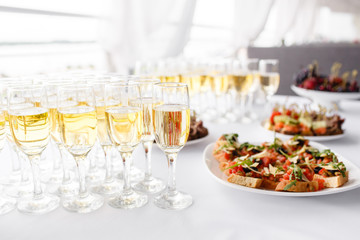 Lot of glasses champagne or wine on the table in restaurant. buffet table with lots of delicious...