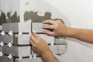 Laying Ceramic Tiles. The Builder makes repairs.