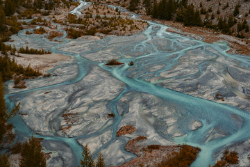 alluvial land of a wild running glacial creek in the swiss alps