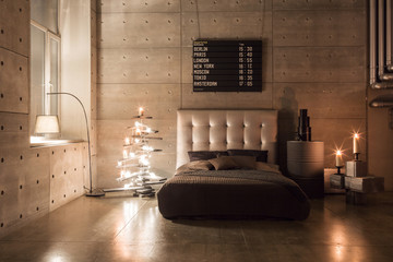 Modern empty bedroom in loft style with grey colors and wooden hand made Christmas tree with...