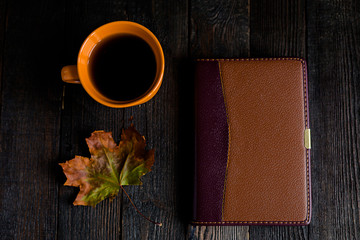 Atumn flat lay on black,dry leave, blacknote, tea