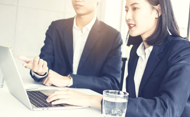 Business people team planning, pointing and discussing about finance  and profit of company