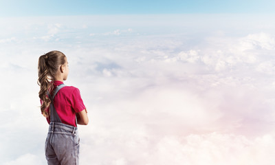 Concept of careless happy childhood with girl looking in future