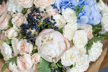 Rich bunch of peonies, roses and hydrangea flowers, green leaf. Fresh spring bouquet. Summer Background. Selective focus.