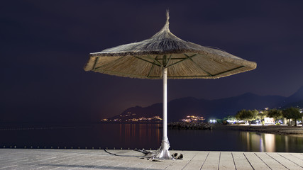 Evening view of isolated bamboo parasol by the sea