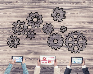 Top view of businesspeople sitting at table and using gadgets