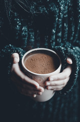 A cup of hot drink in hands