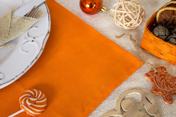 christmas table setting in orange colors and in rustic style