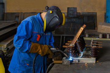 Welding works in assembly production.