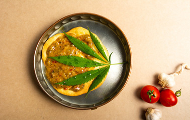 Pastry with marijuana paste topping on a tray