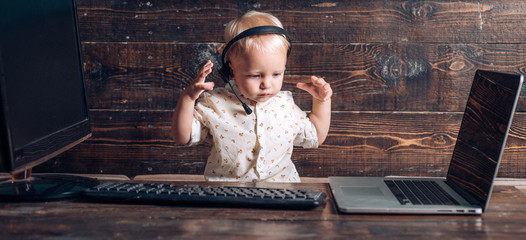 Kid boy in headset with microphone in call centre. Call centre operator using computer technology