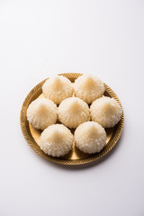 Sweet Modak made using coconut, khoya and sugar. Popular Maharashtrian recipe offered to lord Ganesha in Ganesh Festival. Served in a plate. Selective focus