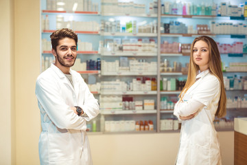 Fototapeta na wymiar Female and male pharmacists in pharmacy
