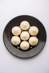Sweet Modak made using coconut, khoya and sugar. Popular Maharashtrian recipe offered to lord Ganesha in Ganesh Festival. Served in a plate. Selective focus