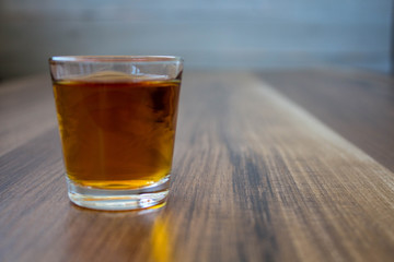 a pile of whiskey on a wooden background