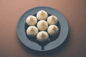 Sweet Modak made using coconut, khoya and sugar. Popular Maharashtrian recipe offered to lord Ganesha in Ganesh Festival. Served in a plate. Selective focus