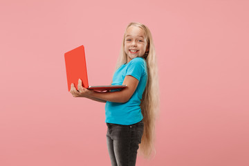 Teen girl with laptop. Love to computer concept. Attractive female half-length front portrait, trendy pink studio backgroud. Young emotional woman. Human emotions, facial expression concept.