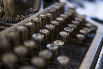 Close up view on an old dirty broken antique typewriter machine keys with Cyrillic symbols letters.