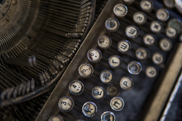 Close up view on an old dirty broken antique typewriter machine keys with Cyrillic symbols letters.