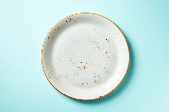 White plate on blue background, from above