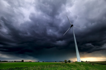dramatic storm sky and wind turbine