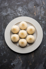 Sweet Modak made using coconut, khoya and sugar. Popular Maharashtrian recipe offered to lord Ganesha in Ganesh Festival. Served in a plate. Selective focus