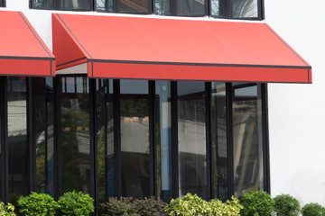 orange awning over glass windows and black aluminium frame, canvas shading