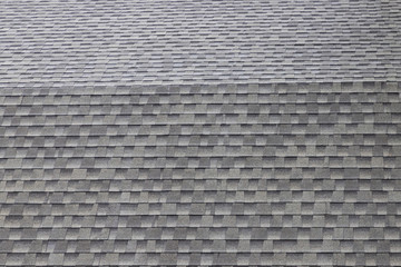 wet roof shingles background and texture. angle slop of asphalt roof. © Rattanachat