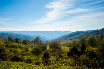 Beautiful landscape of summer mountains with blue sky. Autumn mountain village panoramic landscape