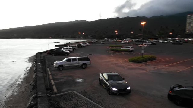 Sunset on the coast of Honolulu in Hawaii. Boats, Jets Skis, and Cars
