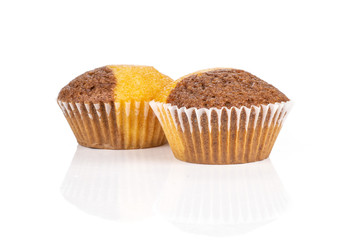 Group of two whole sweet fresh baked marble muffin isolated on white background