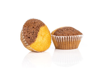 Group of two whole tasty fresh baked marble muffin isolated on white background