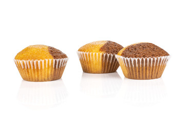 Group of three whole fresh baked marble muffin isolated on white background