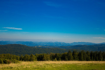 Fototapeta na wymiar Beautiful landscape of summer mountains with blue sky. Autumn mountain village panoramic landscape