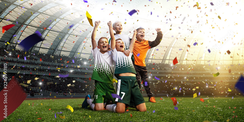 Wall mural winning football player children after score in a match confetti and tinsel