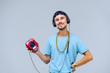 fashionable bright man in headphones in retro style manifestation of emotions of joy, gestures with hands space for text