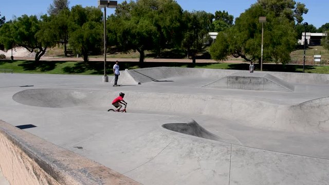 Three generations of skateboarders meet at the lip of the Wedge Skate Park Eldorado Park Scottsdale Arizona?