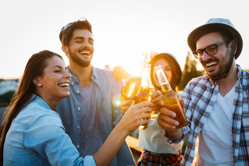 Group of happy friends having party on rooftop