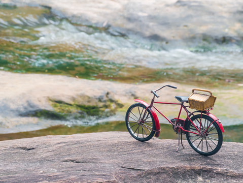 Red bicycle on stone