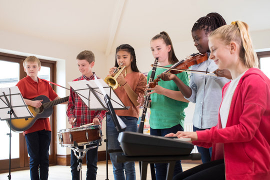 High School Students Playing In School Orchestra Together - Powered by Adobe