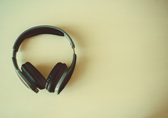 Earphone on white wooden background, image vintage background,