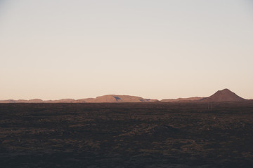 Naklejka premium Large field with mountain in the distance in Iceland