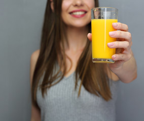 Woman holding glass with orange guice.