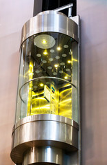 Modern moving elevator in shopping centre. Glass lift. © orelphoto