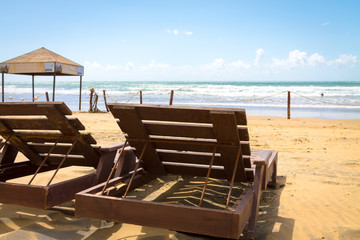 Two wooden sun beds are deployed to the ocean. The coast of the Atlantic Ocean. The beach is near Agadir. Africa Morocco
