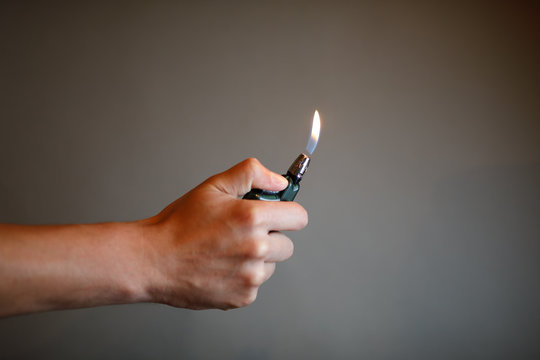 cigarette lighter igniting by a hand