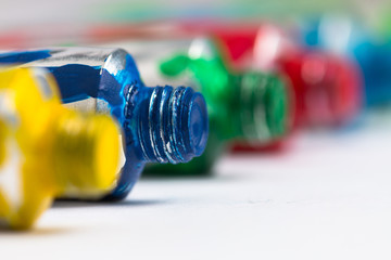 Colorful acrylic paint tubes on white background. Artistic background.